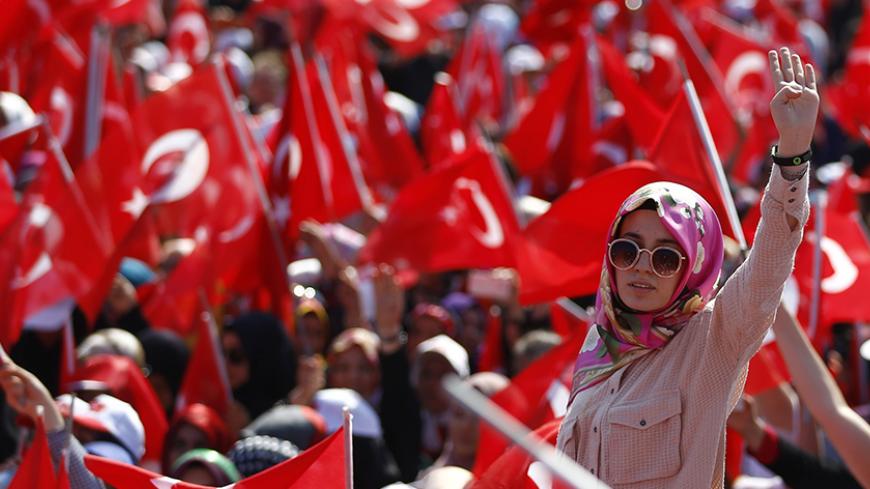 A woman reacts as she attends the Democracy and Martyrs Rally, organized by Turkish President Tayyip Erdogan and supported by ruling AK Party (AKP), oppositions Republican People's Party (CHP) and Nationalist Movement Party (MHP), to protest against last month's failed military coup attempt, in Istanbul, Turkey, August 7, 2016.  REUTERS/Osman Orsal - RTSLJVF