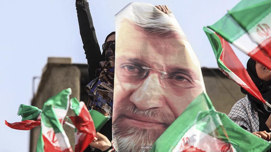 A supporter of Iranian presidential candidate Saeed Jalili holds his picture during a rally in Tehran June 12, 2013. Picture taken June 12, 2013.  REUTERS/Yalda Moayeri   (IRAN - Tags: POLITICS ELECTIONS) - RTX10M0X