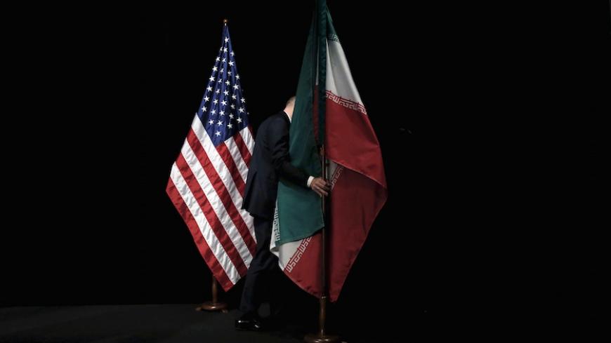 A staff member removes the Iranian flag from the stage during the Iran nuclear talks in Vienna, Austria July 14, 2015. Carlos Barria: For more than a decade the United States and other world powers have participated in talks to reach an agreement on Iranís nuclear program. They and Iran have spent thousands of hours around a table seeking a solution to what the West sees as a threat to global stability if Iran gains the capability to make a nuclear bomb. The last chapter was in Vienna, where I travelled wit