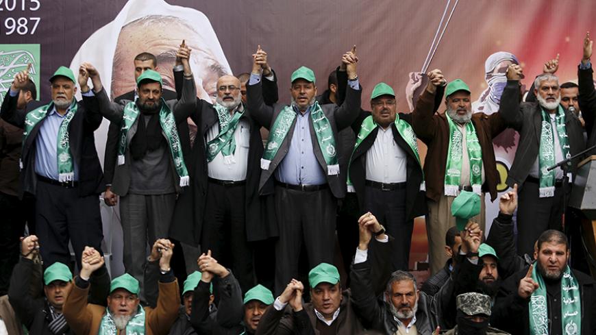 Hamas leaders (top) join hands as they take part in a rally marking the 28th anniversary of Hamas' founding, in Gaza City December 14, 2015. REUTERS/Suhaib Salem - RTX1YLNB