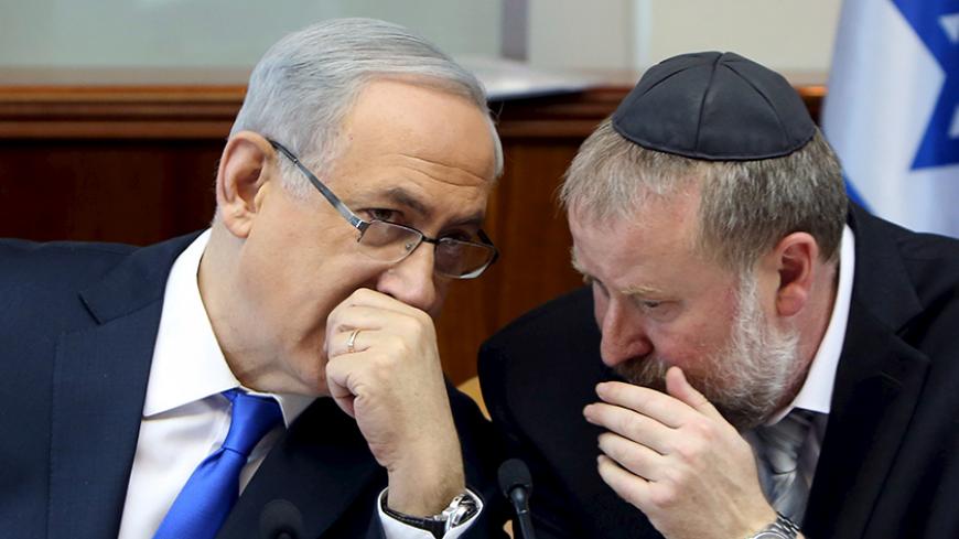 Israeli Prime Minister Benjamin Netanyahu (L) speaks with Cabinet Secretary Avichai Mandelblit during the weekly cabinet meeting in Jerusalem December 20, 2015. REUTERS/Gali Tibbon/Pool  - RTX1ZGHK