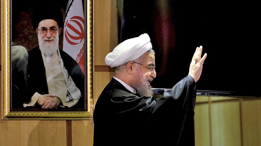 Iranian President Hassan Rouhani waves as he stands next to a portrait of Iran's Supreme Leader Ayatollah Ali Khamenei, after he registered for February's election of the Assembly of Experts, the clerical body that chooses the supreme leader, at Interior Ministry in Tehran December 21, 2015. REUTERS/Raheb Homavandi/TIMA ATTENTION EDITORS - THIS IMAGE WAS PROVIDED BY A THIRD PARTY. FOR EDITORIAL USE ONLY. TPX IMAGES OF THE DAY     - RTX1ZKHQ
