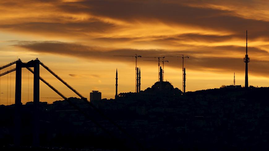 The sun rises behind the Bosphorus Bridge (L) and the construction site of the new Camlica Mosque in Istanbul, Turkey, February 3, 2016. REUTERS/Murad Sezer - RTX257J9
