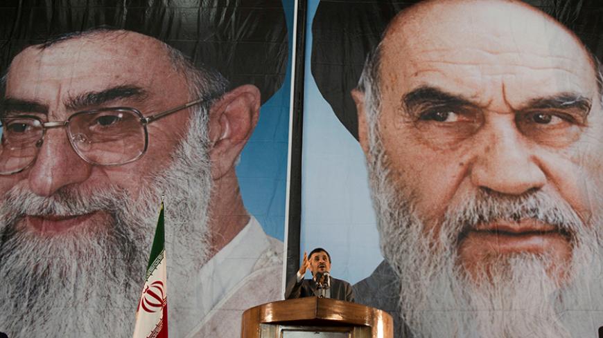 Iranian President Mahmoud Ahmadinejad stands under pictures of Iran's Supreme Leader Ayatollah Ali Khamenei (L) and Iran's late leader Ayatollah Ruhollah Khomeini while speaking during a ceremony to mark Khomeini's death anniversary at his tomb at Tehran's Behesht-Zahra cemetery June 3, 2011. REUTERS/Morteza Nikoubazl/File Photo - RTX2DZ1L