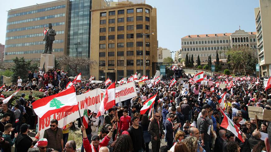 Protesters wave Lebanese national flags during a demonstration against proposed tax increase, in front of the government palace in Beirut, Lebanon March 19, 2017. REUTERS/Alia Haju - RTX31PEJ