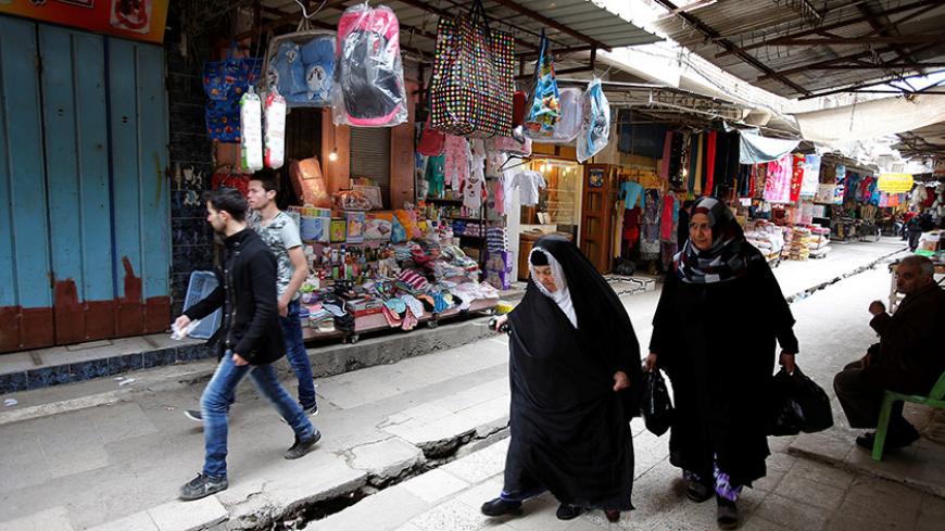 People do shopping at Nabi Yunus market after returning to their homes in the city of Mosul, Iraq Picture taken March 19, 2017. REUTERS/Youssef Boudlal - RTX32IG2