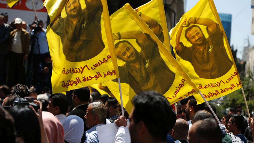 Protesters wave flags bearing a portrait of prominent jailed Palestinian Marwan Barghouti during a rally in the West Bank city of Ramallah to show their support to Palestinians detained in Israeli jails after hundred of them launched a hunger strike on April 17, 2017.
More than 1,000 Palestinians in Israeli jails launched a hunger strike following a call from Barghouti, a Palestinian Authority official said. / AFP PHOTO / ABBAS MOMANI        (Photo credit should read ABBAS MOMANI/AFP/Getty Images)