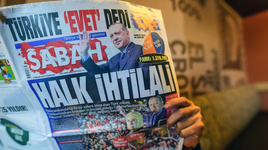 A man reads Sabah newspaper bearing a headline which translates as "Revolution of people"" in Istanbul on April 17, 2017, a day after Turkey's referendum. 
The deputy leader of Turkey's opposition Republican People's Party (CHP) called on April 17, 2017 for the results of a referendum agreeing new powers for President Recep Tayyip Erdogan to be annulled. / AFP PHOTO / YASIN AKGUL        (Photo credit should read YASIN AKGUL/AFP/Getty Images)