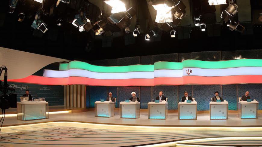 Iranian presidential candidates (L to R) Mostafa Mirsalim, Hassan Rouhani, Mohammad Baqer Qalibaf, Eshaq Jahangiri and Ebrahim Raisi attend a live debate on state TV in Tehran on April 28, 2017. 
Iran will air live debates on state television ahead of May's presidential election, the interior ministry, reversing a decision to show recorded versions that had triggered an outcry. / AFP PHOTO / JAMEJAMONLINE / MEHDI DEHGHAN