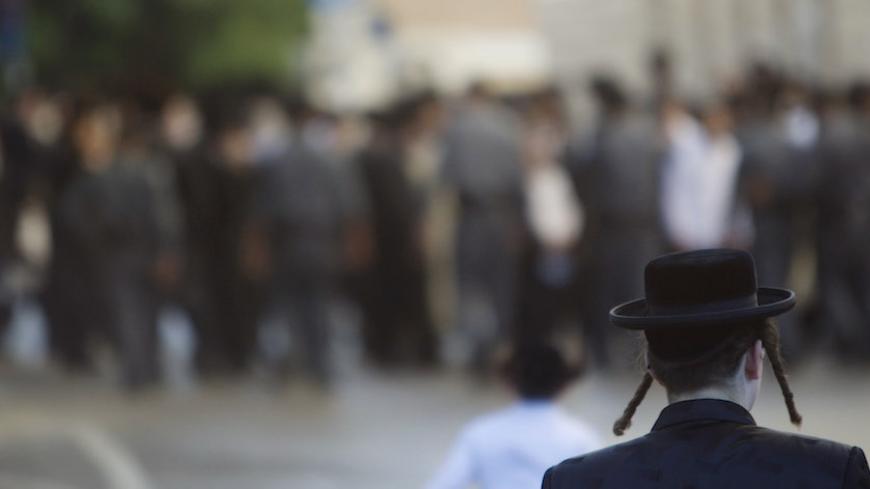 An ultra-Orthodox Jew takes part in a protest against the opening of a road on the Sabbath, near a religious neighbourhood in Jerusalem June 23, 2012. REUTERS/Ronen Zvulun (JERUSALEM - Tags: RELIGION CIVIL UNREST) - RTR3427P
