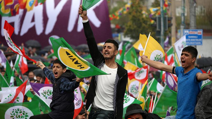 Supporters of Turkey's pro-Kurdish opposition Peoples' Democratic Party (HDP) shout slogans during a rally for the upcoming referendum in the southeastern city of Diyarbakir, Turkey, April 15, 2017. REUTERS/Sertac Kayar - RTS12FFG