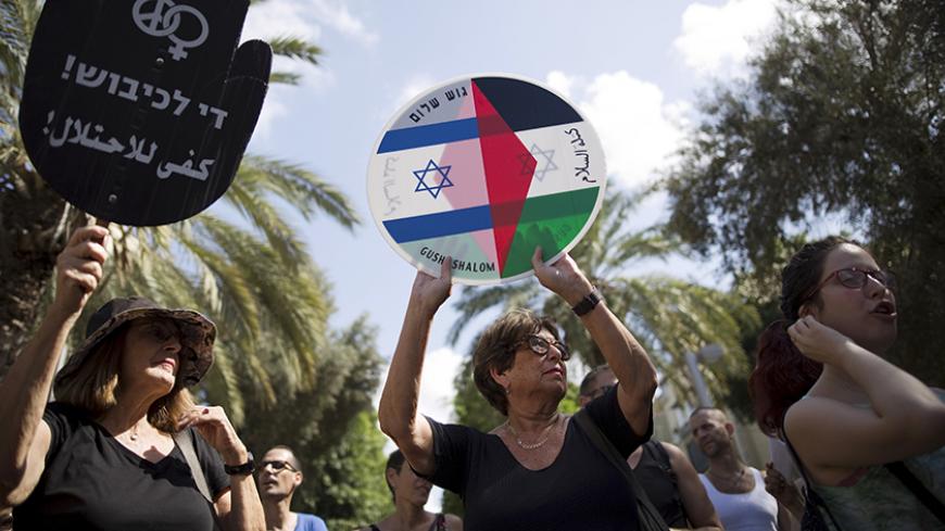 Left-wing Israeli protesters hold placards during a demonstration against the recent Palestinian-Israeli violence in Tel Aviv, Israel October 9, 2015. In the past 10 days, four Israelis have been shot or stabbed to death in Jerusalem and the occupied West Bank, and at least a dozen have been wounded by Palestinians wielding knives or screwdrivers in stabbings in Tel Aviv and other Israeli cities. Three Palestinians have also been killed, and scores wounded in clashes with Israeli security forces during ston