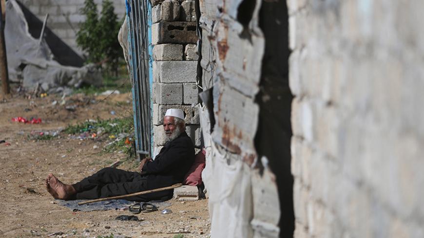 A Palestinian man sits outside his dwelling in Khan Younis in the southern Gaza Strip, December 1, 2015. REUTERS/Ibraheem Abu Mustafa      - RTX1WP0W