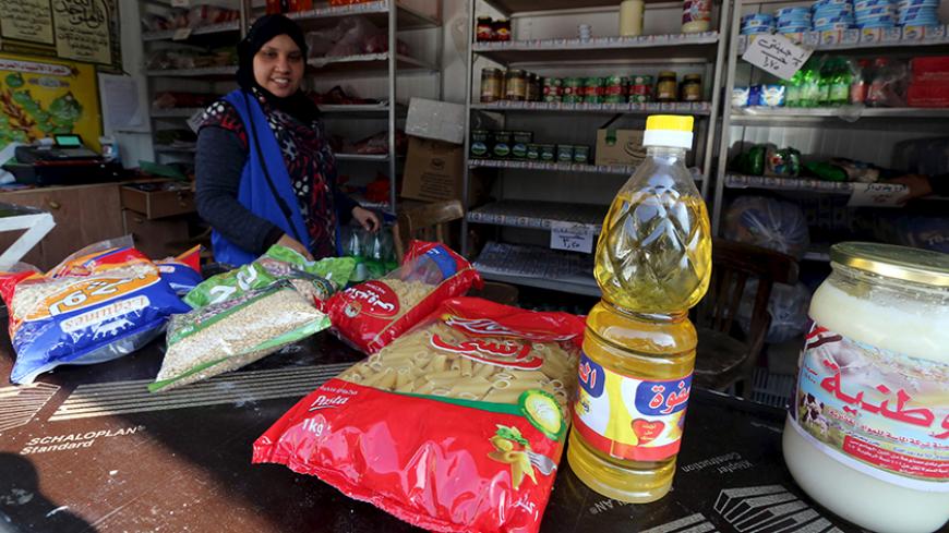 A worker sells subsidized food commodities at a government-run supermarket in Cairo, Egypt, February 14, 2016. Tens of millions of Egyptians rely on state subsidies provided as credits on smartcards they redeem against household staples each month. But in recent weeks, imported commodities like cooking oil have been in short supply as a dollar shortage makes it harder for state importers to secure regular supplies. Picture taken February 14, 2016. REUTERS/Mohamed Abd El Ghany - RTX27KYO