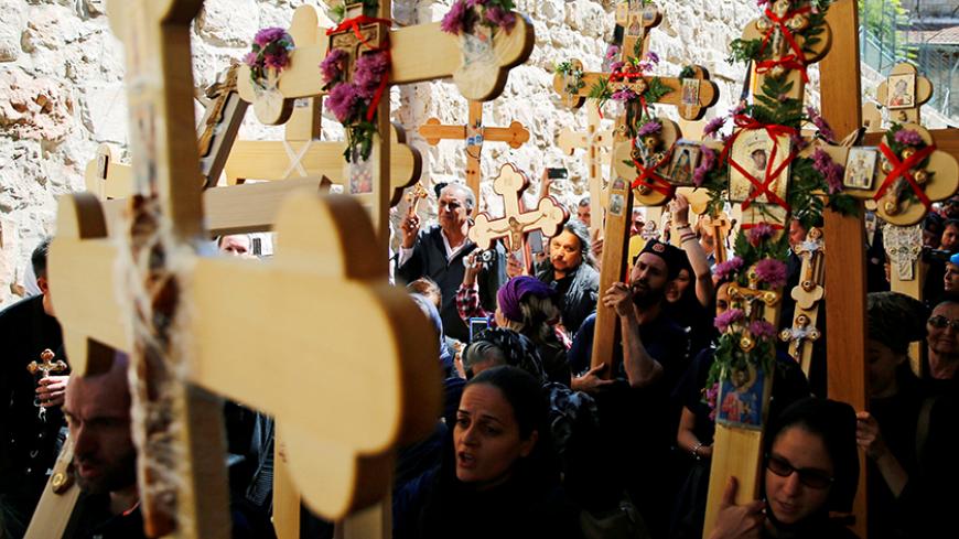Orthodox Christian worshippers hold crosses before a procession along the Via Dolorosa on Good Friday during Holy Week in Jerusalem's Old City April 29, 2016. REUTERS/Ammar Awad - RTX2C6DI