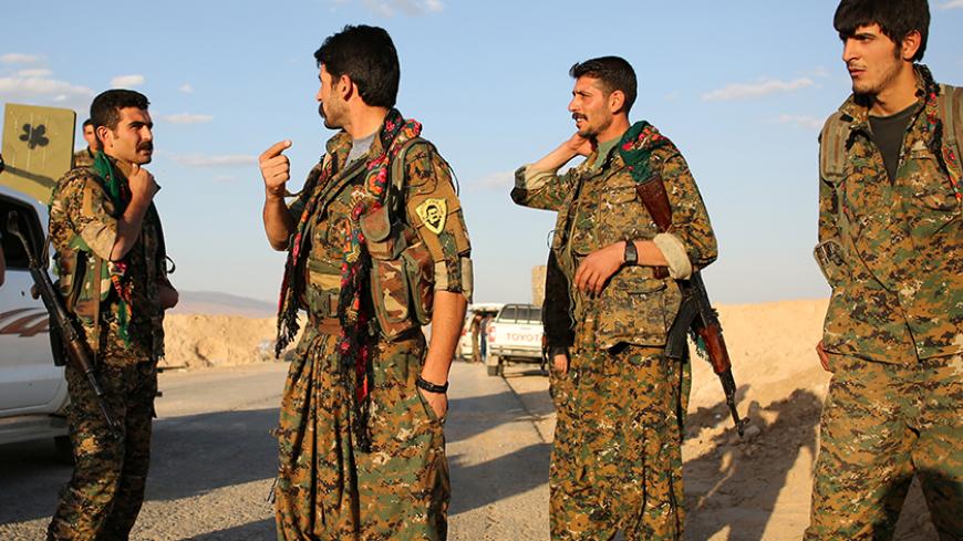 Members of the Sinjar Resistance Units (YBS), a militia affiliated with the Kurdistan Workers’ Party (PKK), stand in the village of Umm al-Dhiban, northern Iraq, April 29, 2016. They share little more than an enemy and struggle to communicate on the battlefield, but together two relatively obscure groups have opened up a new front against Islamic State militants in a remote corner of Iraq. The unlikely alliance between the Sinjar Resistance Units, an offshoot of a leftist Kurdish organisation, and Abdulkhal