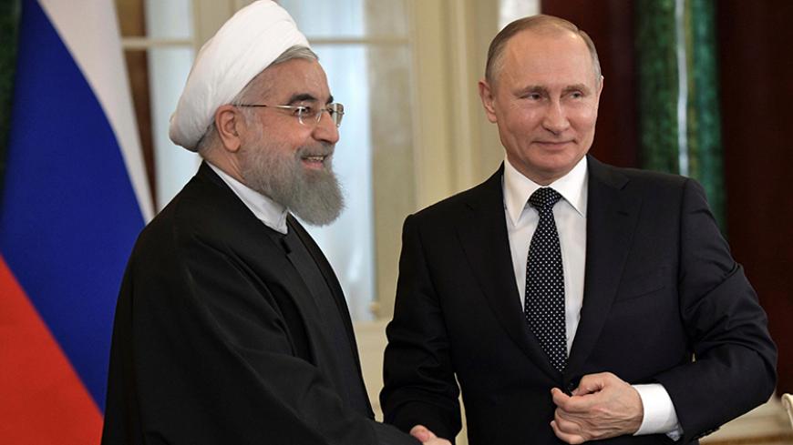 Russian President Vladimir Putin shakes hands with Iranian President Hassan Rouhani during a joint news conference following their meeting at the Kremlin in Moscow, Russia March 28, 2017.  Sputnik/Aleksey Nikolskyi/Kremlin via REUTERS ATTENTION EDITORS - THIS IMAGE WAS PROVIDED BY A THIRD PARTY. EDITORIAL USE ONLY. - RTX33354