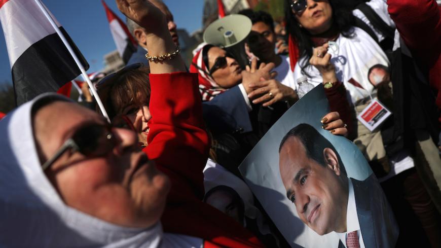 Supporters of Egypt's President Abdel Fattah al-Sisi gather outside the White House prior to his arrival for a meeting with U.S. President Donald Trump in Washington, U.S., April 3, 2017. REUTERS/Carlos Barria - RTX33VYB