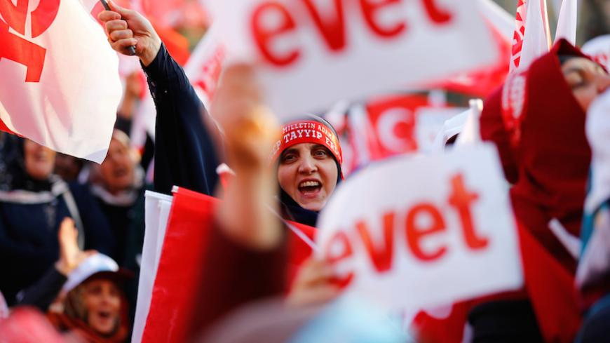 Supporters of Turkish President Recep Tayyip Erdogan hold "Yes" campaign flags and "Yes" banners during a rally for the upcoming referendum in the Black Sea city of Trabzon, Turkey April 3, 2017. REUTERS/Umit Bektas - RTX33WEX