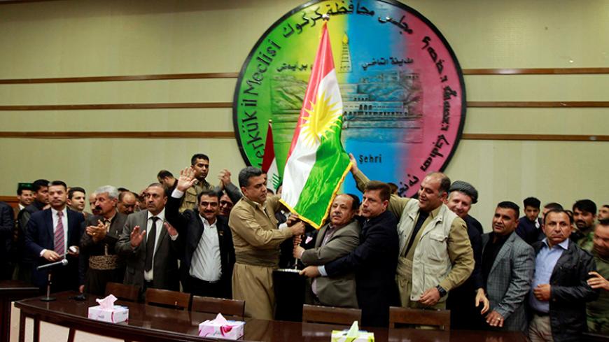 Kurdish parties raise the Kurdish flag at the Kirkuk Governorate Council in Kirkuk, Iraq, April 6, 2017. REUTERS/Ako Rasheed - RTX34DGA