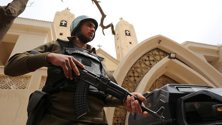 An armed policeman secures the Coptic church that was bombed on Sunday in Tanta, Egypt April 10, 2017. REUTERS/Mohamed Abd El Ghany - RTX34WSO