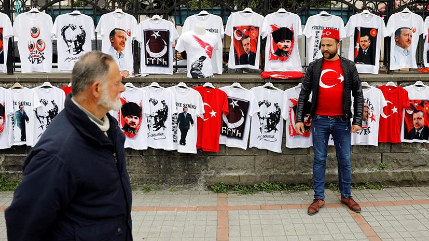 A street vendor sells t-shirts with portraits of modern Turkey's founder Mustafa Kemal Ataturk and Turkish President Tayyip Erdogan during a rally for the upcoming referendum in the Black Sea city of Rize, Turkey, April 3, 2017. Picture taken April 3, 2017. REUTERS/Umit Bektas - RTX34ZRF