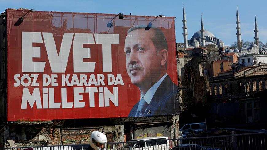 A billboard carrying a picture of Turkish President Tayyip Erdogan and a slogan that reads: "Yes. It is for the people to speak and to decide" is seen on a building ahead of the constitutional referendum in Istanbul, Turkey April 13, 2017. REUTERS/Murad Sezer - RTX35F8G