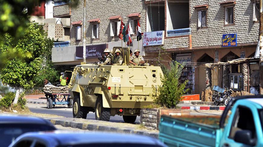 An Egyptian military armoured personnel carrier patrols a street in the Sheikh Zowied town near Rafah, in the northern Sinai on May 20, 2013. Egypt sent police reinforcements to the Sinai after an attack on a police camp in the wake of the kidnapping of seven security personnel in the lawless peninsula, officials said. AFP PHOTO/MOHAMED EL-SHAHED        (Photo credit should read MOHAMED EL-SHAHED/AFP/Getty Images)