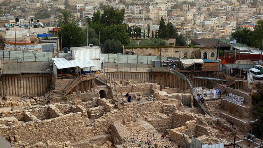A general view shows workers from the Israeli Antiquity Authorities digging on November 3, 2015 at the excavation site near the City of David adjacent to Jerusalem's Old City walls, where researchers believe to have found the remains of the stronghold the Acra, from which the Greek King Antiochus IV was able to control Jerusalem and monitor activity at the holy site known to Jews as the Temple Mount. Israel's antiquities body claimed to have solved "one of Jerusalem's greatest archeological mysteries" by un