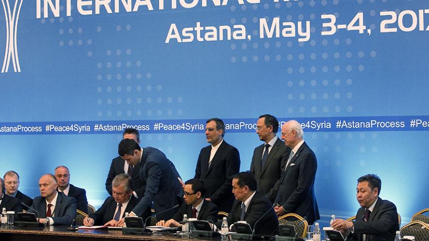 CORRECTION - Russian mediator Alexander Lavrentiev, Iranian deputy foreign minister Hossein Jaberi Ansari, Kazakh Foreign Minister Kairat Abdrakhmanov and UN Special Envoy for Syria Staffan de Mistura attend the signing of a memorandum on creating safe zones in Syria during the fourth round of Syria peace talks in Astana on May 4, 2017. / AFP PHOTO / Stanislav FILIPPOV / The erroneous mention[s] appearing in the metadata of this photo by Stanislav FILIPPOV has been modified in AFP systems in the following m