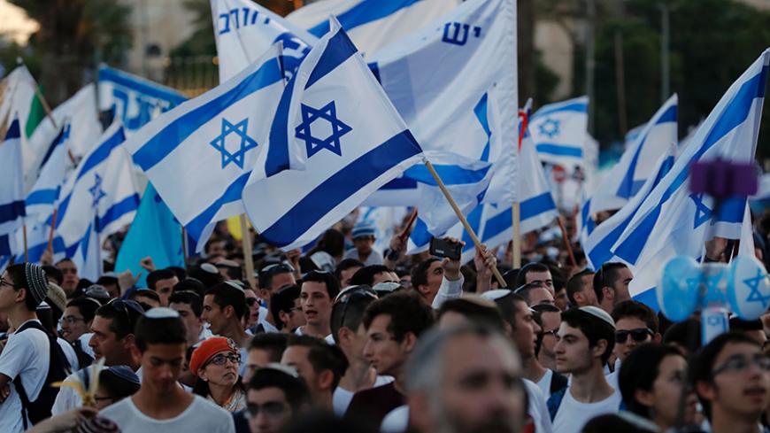 Far right Israeli supporters wave the Israeli flag as they demonstrate on May 24, 2017 in front of Damascus Gate in Jerusalem's Old City to commemorate Jerusalem Day, marking the establishment of Israeli control over the Old City following its capture in the Six-Day War of 1967.  / AFP PHOTO / Thomas COEX        (Photo credit should read THOMAS COEX/AFP/Getty Images)