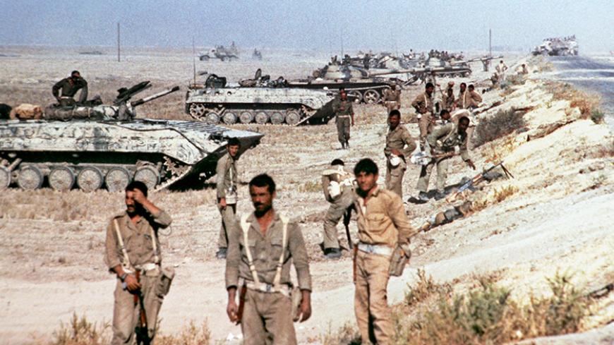 Picture released on October 1980 of Iraqi soldiers standing in front of tanks and looking at Khorramshahr, near Chatt-el-Arab, in Iran, as fights between Iran and Iraq started again despite the cease-fire. (Photo credit should read -/AFP/Getty Images)