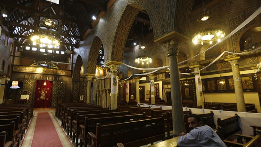 A worker rests at The Hanging Church as Egypt's Minister of Antiquities Mamdouh Eldamaty (unseen) tours the grounds, which forms one of the religious communities in Old Cairo, for a tourism development project August 19, 2014. Egypt's tourism revenue dropped by 24.7 percent to around $3 billion in the first half of 2014, the Ministry of Tourism said in a statement. REUTERS/Amr Abdallah Dalsh (EGYPT - Tags: BUSINESS RELIGION TRAVEL) - RTR42Y3N