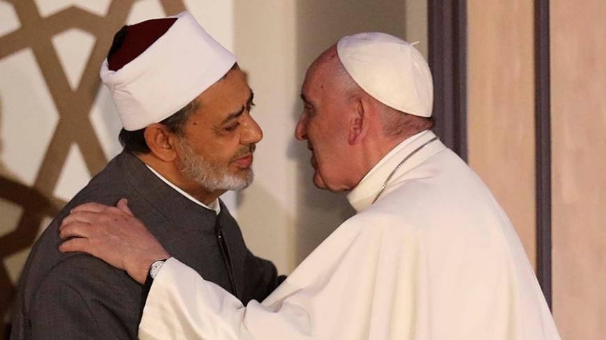 Pope Francis embraces Ahmed al-Tayeb, Grand Imam of Egypt's al-Azhar Institution in Cairo, Egypt April 28, 2017. REUTERS/Mohamed Abd El Ghany - RTS14CWC