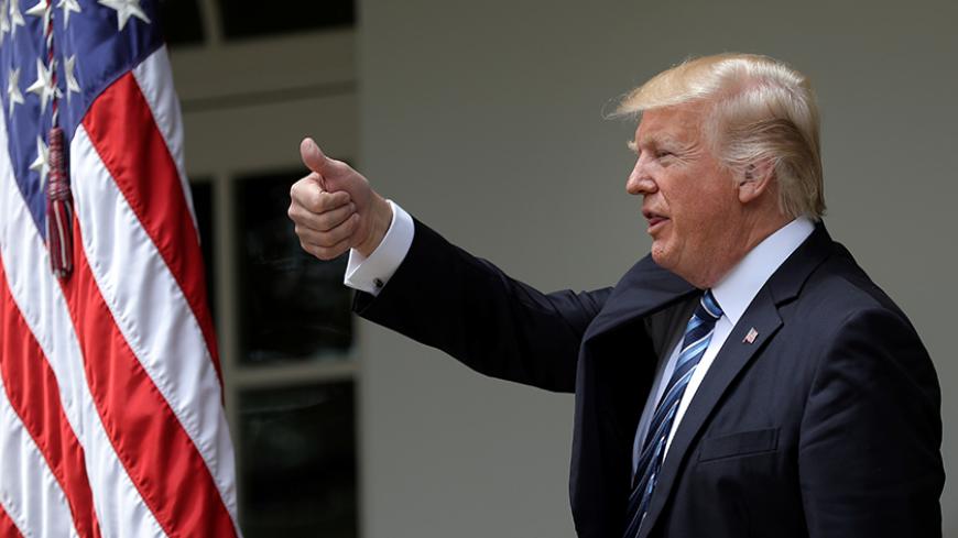 U.S. President Donald Trump gives a thumbs up during a National Day of Prayer event at the Rose Garden of the White House in Washington D.C., U.S., May 4, 2017. REUTERS/Carlos Barria - RTS156JI
