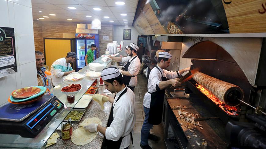 Syrians work at a Syrian restaurant in an area called 6 October City in Giza, Egypt, March 19, 2016. Attracting visitors from across the country, a market mostly run by Syrians fleeing the war has recently gained popularity in Giza. The area, in 6 October City, is known as 'Little Damascus' due to its large Syrian population, as well as eateries and shops selling traditional Syrian delicacies.  REUTERS/Mohamed Abd El Ghany - RTSBVU7