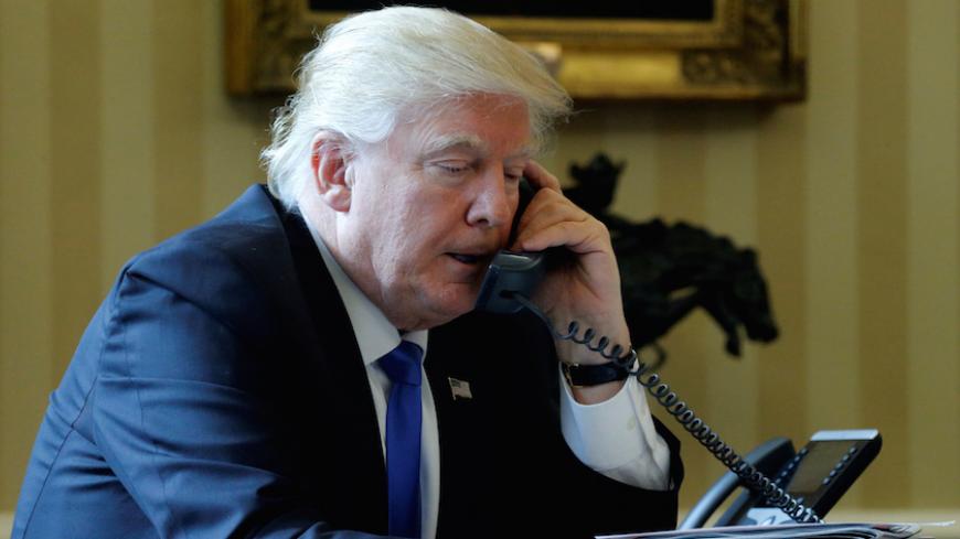 U.S. President Donald Trump speaks by phone with Russia's President Vladimir Putin in the Oval Office at the White House in Washington, U.S. January 28, 2017. REUTERS/Jonathan Ernst - RTSXT5Q