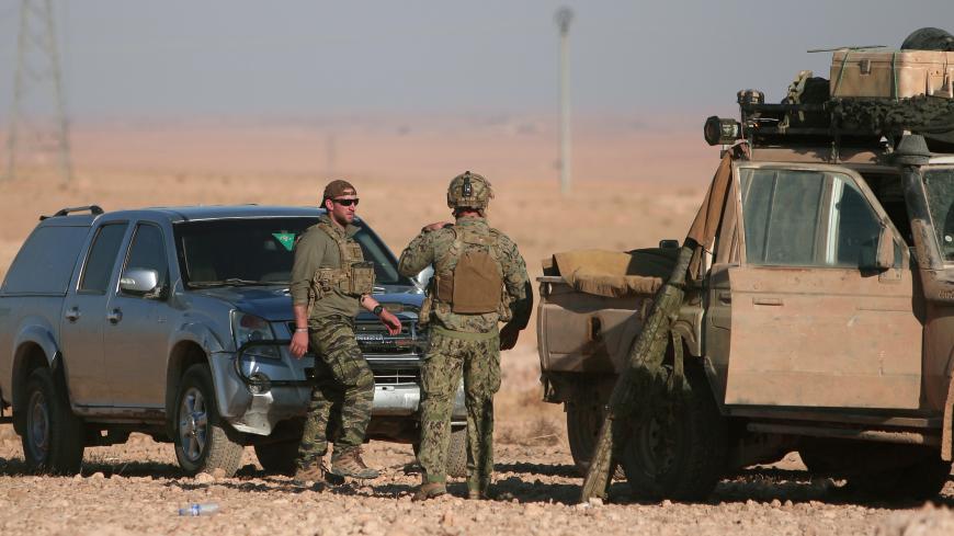 U.S. fighters stand near military vehicles, north of Raqqa city, Syria November 6, 2016. REUTERS/Rodi Said - RTX2S5R9