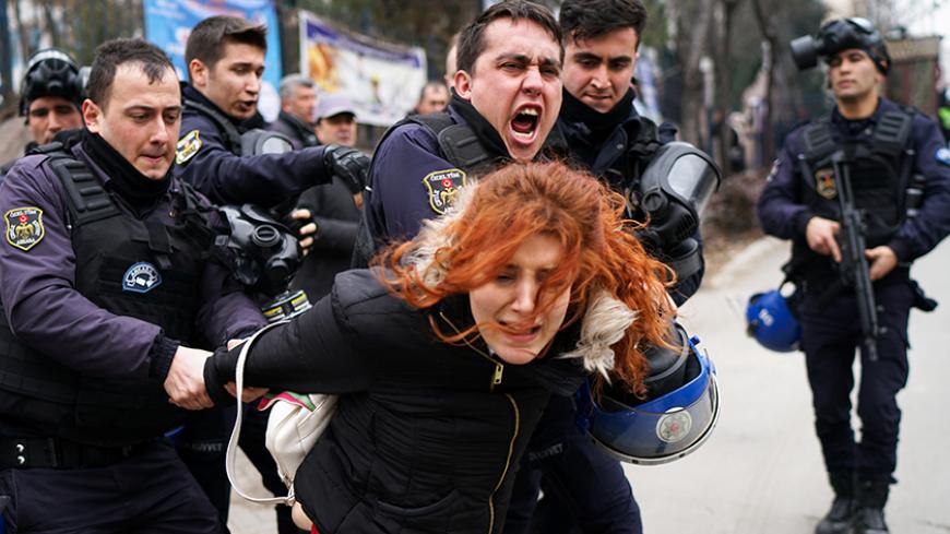 Riot police detain a demonstrator during a protest against the dismissal of academics from universities following a post-coup emergency decree, outside the Cebeci campus of Ankara University in Ankara, Turkey, February 10, 2017. REUTERS/Umit Bektas     TPX IMAGES OF THE DAY - RTX30FAC