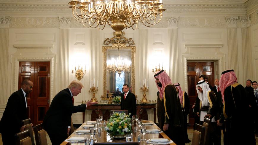 U.S. President Donald Trump and Saudi Deputy Crown Prince and Minister of Defense Mohammed bin Salman take their seats for lunch in the State Dining Room of the White House  in Washington, U.S., March 14, 2017. REUTERS/Kevin Lamarque - RTX30ZV5