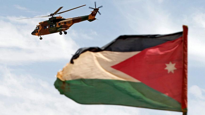 A helicopter is seen next to the Jordanian flag during the Eager Lion military exercise at the Jordan-Saudi Arabia border, south of Amman May 17, 2017. REUTERS/Muhammad Hamed - RTX36760
