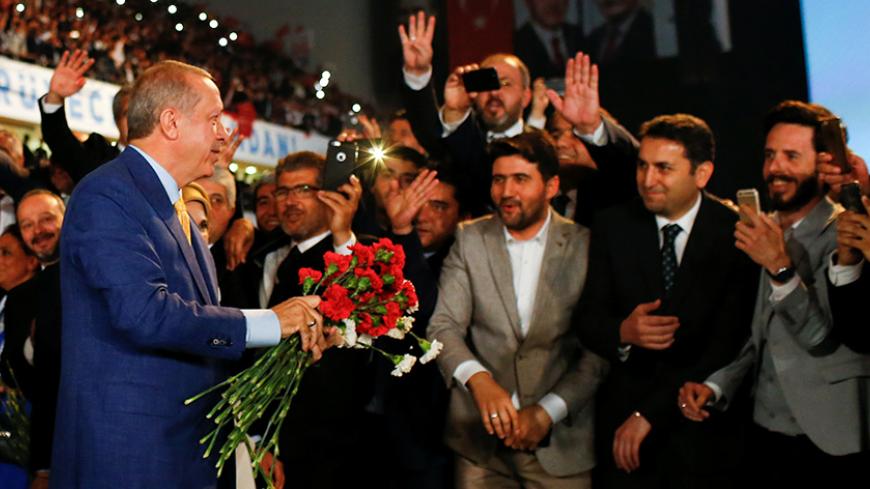 Turkish President Tayyip Erdogan, gives flowers to his supporters upon arriving at the Extraordinary Congress of the ruling AK Party (AKP) in Ankara, Turkey, May 21, 2017. REUTERS/Murad Sezer     TPX IMAGES OF THE DAY - RTX36ST1