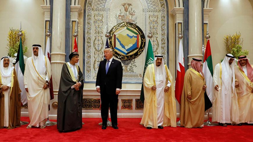 U.S. President Donald Trump (4-L) speaks with Oman's Deputy Prime Minister Fahd bin Mahmoud Al-Said (3-L) during a family photo with Gulf Cooperation Council leaders at their summit in Riyadh, Saudi Arabia May 21, 2017. REUTERS/Jonathan Ernst - RTX36TI7