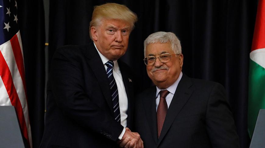 U.S. President Donald Trump and Palestinian President Mahmoud Abbas shake hands as they conclude their remarks after their meeting at the Presidential Palace in the West Bank city of Bethlehem May 23, 2017. REUTERS/Jonathan Ernst - RTX375M9