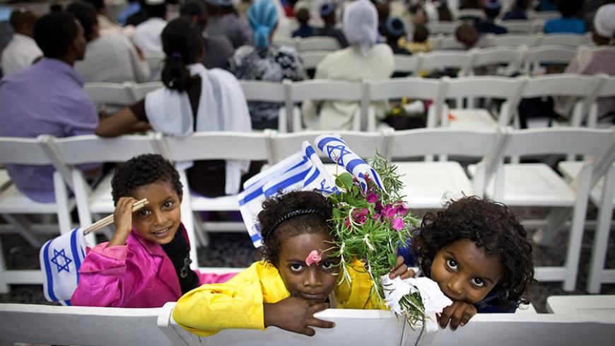 TEL AVIV, ISRAEL - OCTOBER 29: New Jewish immigrants during a welcoming ceremony after arriving on a flight from Ethiopia, on October 29, 2012 at Ben Gurion airport near Tel Aviv, Israel. Some 240 Ethiopian Jews have arrived on a flight to Tel Aviv. The flight is the first of a series of monthly flights planned as part of Operation Dove's Wings, an Israeli government initiative to bring to Israel the remainder of the Falash Mura, members of the Ethiopian Jewish community who converted to Christianity during