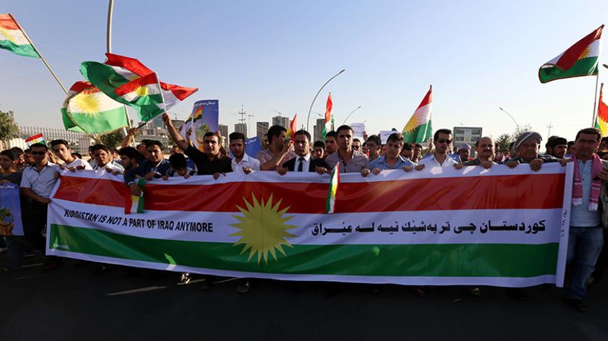 Iraqi Kurdish demonstrators wave the Kurdish flag during a protest demanding for the independence of Kurdistan outside the United Nations offices in Arbil, the capital of the autonomous Kurdish region, on August 23, 2014. About 700,000 Iraqis have gathered in the Kurdish north after being driven from their homes by jihadist Islamic State (IS) fighters, the UN said as it stepped up a massive aid operation to the region. AFP PHOTO / SAFIN HAMED        (Photo credit should read SAFIN HAMED/AFP/Getty Images)