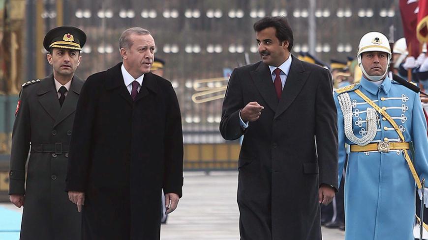 Qatari Crown Prince Sheikh Tamim bin Hamad bin Khalifa al-Thani (2ndR) and Turkish President Recep Tayyip Erdogan (2ndL), walk past a guard of honor during an official welcoming ceremony prior to their meeting at the presidential palace in Ankara, Turkey, on December 19, 2014. AFP PHOTO / ADEM ALTAN        (Photo credit should read ADEM ALTAN/AFP/Getty Images)
