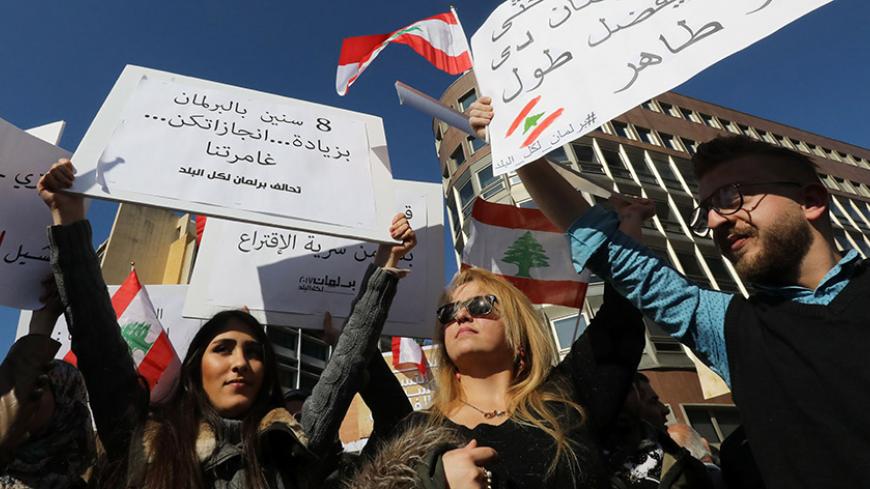 Lebanese activists and protesters hold placards during a demonstration calling for the adoption of a proportional election law, on January 22, 2017, in the capital Beirut. / AFP / ANWAR AMRO        (Photo credit should read ANWAR AMRO/AFP/Getty Images)