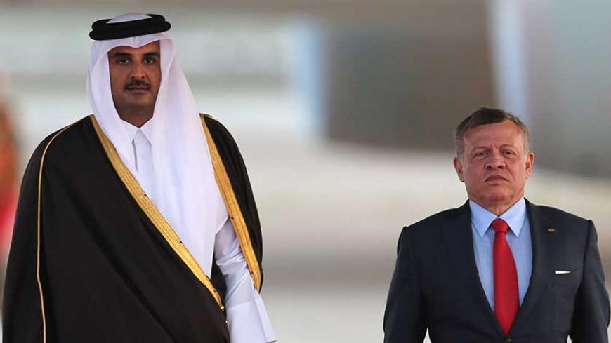 CORRECTION - Jordan's King Abdullah II (R) and Qatar's Emir Sheikh Tamim bin Hamad al-Thani attend a welcome ceremony at the Queen Alia International Airport in Amman on March 28, 2017 ahead of talks on the eve of the Arab League summit. / AFP PHOTO / Khalil MAZRAAWI / The erroneous byline appearing in the metadata of this photo by Khalil MAZRAAWI has been modified in AFP systems in the following manner: [Khalil MAZRAAWI] instead of [Marwan IBRAHIM]. Please immediately remove the erroneous mention[s] from a