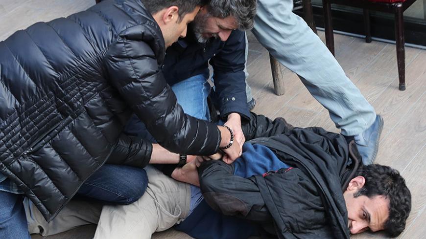 Turkish riot police detain a protester during a demonstration against the arrest by Turkish authorities of an academic and a teacher who have been on a hunger strike, in Ankara, on May 23, 2017.
Turkish authorities detained an academic and a teacher in Ankara who have been on a hunger strike for over two months in protest against their dismissal in the purge that followed last year's failed coup, media reported on May 22. Nuriye Gulmen and Semih Ozakca were sacked under the state of emergency imposed after 